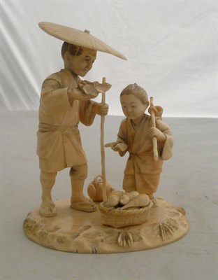 Lot 201 - A Japanese ivory okimono of a peasant and child, circa 1910