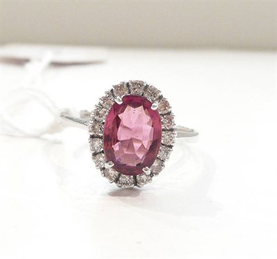 Lot 203 - A 14ct white gold pink tourmaline and diamond cluster ring