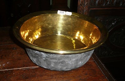 Lot 314 - An 18th century circular brass basin and an oak canteen