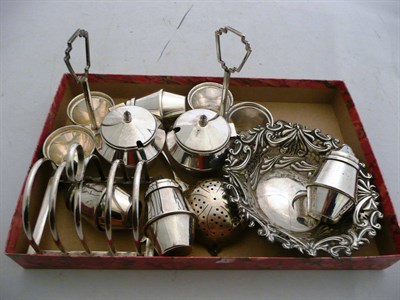 Lot 333 - A silver toast rack, two small cruets, a tea strainer and a silver dish