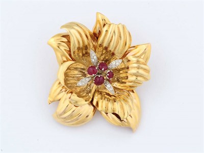 Lot 357 - A Ruby and Diamond Set Stylised Flower Brooch, the shaped double petals are centred by four...