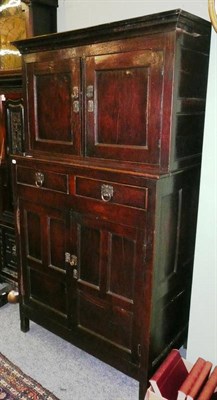 Lot 411 - A 17th century and later oak cupboard, the upper section with moulded cornice above double...