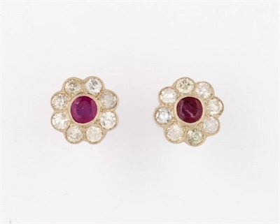 Lot 362 - A Pair of Ruby and Diamond Cluster Earrings, each round cut ruby bordered by eight round...