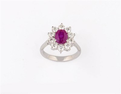 Lot 363 - A Ruby and Diamond Cluster Ring, the oval mixed cut ruby bordered by round brilliant cut...