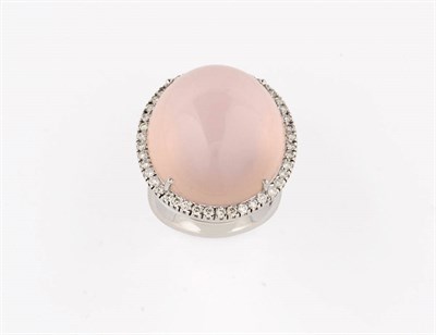 Lot 364 - A Star Rose Quartz and Diamond Cluster Ring, the large cabochon polished rose quartz bordered...