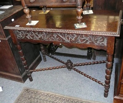 Lot 461 - An oak side table with bobbin turned supports