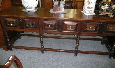 Lot 480 - A Charles II oak low dresser, late 17th century, the later rectangular top with moulded border...