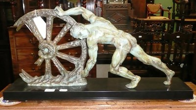 Lot 523 - Art Deco spelter male figure pushing a wheel, on a marble base