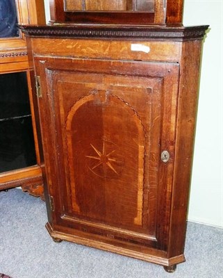 Lot 558 - Inlaid oak corner cabinet raised on feet