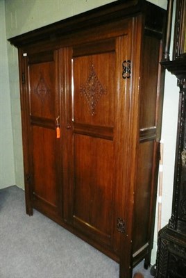 Lot 565 - A 20th century oak cupboard in 17th century style, with broad moulded cornice above two double...