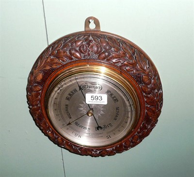 Lot 593 - A circular oak aneroid barometer, acorn design