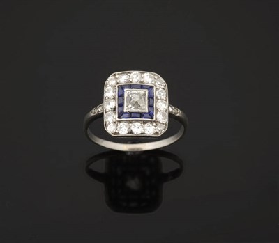 Lot 389 - An Art Deco Diamond and Sapphire Cluster Ring, an octahedron central diamond bordered by a row...