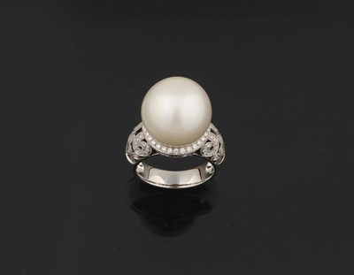 Lot 398 - A Cultured South Sea Pearl and Diamond Ring, the pearl sits over a millegrain set diamond...