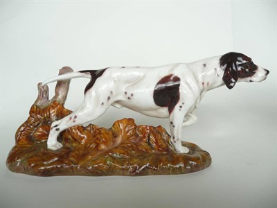 Lot 1084 - Royal Doulton Pointer with tree stump (style one), HN2624, model No. 1312, white with brown...