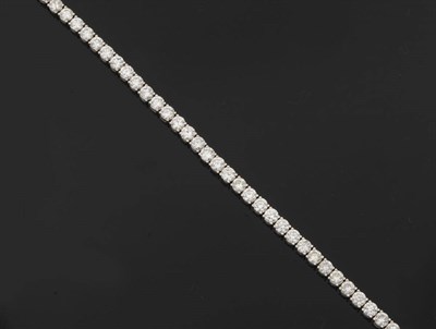 Lot 401 - An 18 Carat White Gold Diamond Line Bracelet, forty-one round brilliant cut diamonds held in...