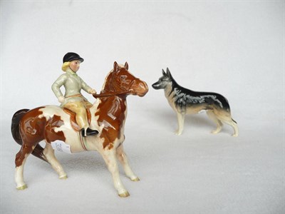 Lot 1096 - Beswick Girl on Skewbald Pony, model No. 1499, brown and white pony, rider in pale green jacket...