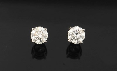 Lot 402 - A Pair of 18 Carat White Gold Diamond Solitaire Stud Earrings, each round brilliant cut diamond...