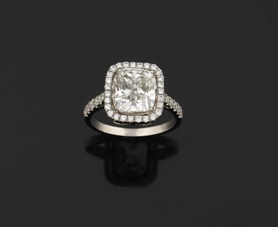 Lot 408 - A Cushion Cut Diamond Ring, the certificated centre stone of 4.01 carat, in a four claw setting...