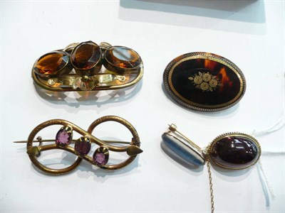 Lot 89 - Two foil-backed brooches, a tortoiseshell pique brooch and an amethyst and citrine-set brooch