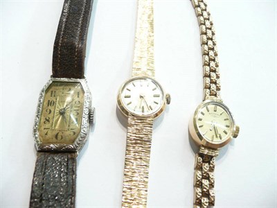 Lot 93 - Two ladies' 9ct gold wristwatches and another lady's wristwatch stamped 14k, (3)