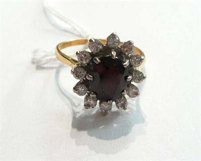 Lot 105 - A diamond and garnet ring