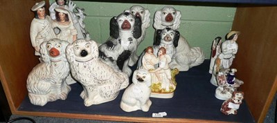 Lot 110 - A shelf of Staffordshire figures including, dogs and flat back figures