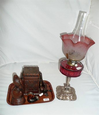 Lot 160 - Cranberry glass lamp, pipe rack and resin figure