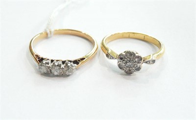 Lot 196 - A diamond three stone ring and a diamond cluster ring