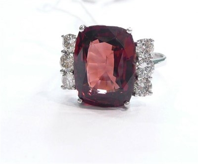 Lot 222 - A 14 carat white gold, garnet and diamond ring