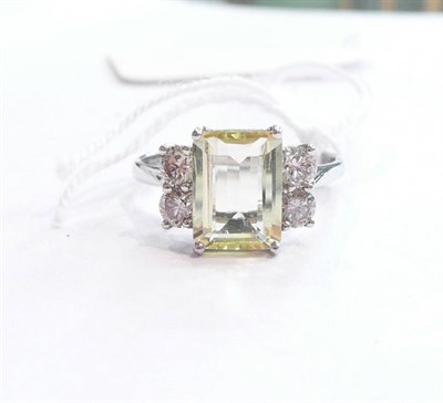 Lot 225 - A 14 carat white gold, yellow stone and diamond ring