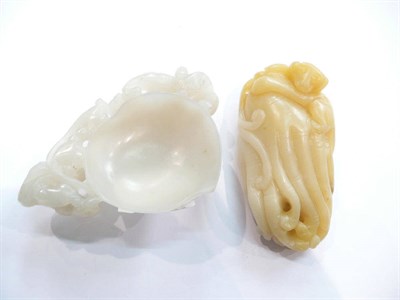 Lot 234 - Chinese carved peach coloured stone finger citron and a mutton fat peach cup (2)