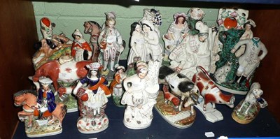 Lot 271 - A shelf of Staffordshire figures including, cow groups, flat back figures, watch holder, spill...