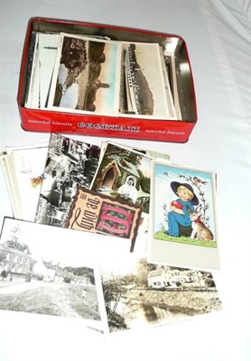 Lot 285 - A collection of approximately 160 pre-war postcards, in a tin