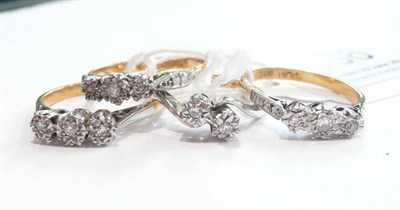 Lot 386 - Three diamond three stone rings and a diamond two stone twist ring (4)