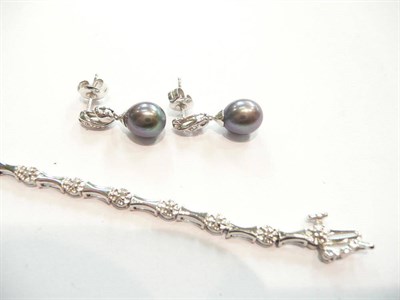 Lot 391 - Diamond and white gold bracelet and black pearl and diamond earrings