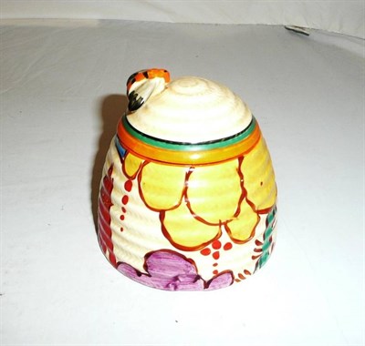 Lot 411 - A Clarice Cliff honey pot and cover