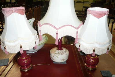 Lot 446 - A pair of red ground and gilt decorated table lamps and a larger table lamp and shade