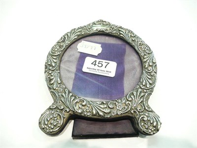 Lot 457 - An embossed silver photograph frame