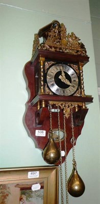 Lot 538 - A reproduction Dutch wall clock with brass weight