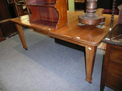 Lot 560 - A light oak draw leaf dining table, leaf, winder