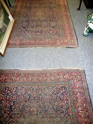 Lot 593 - A pair of Persian blue ground carpets (worn)