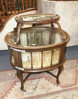 Lot 600 - An early 20th Century oak and glazed two tier display cabinet