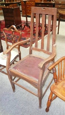 Lot 624 - A Liberty Arts and Crafts oak dining armchair, with high tapered back rails and shaped crest