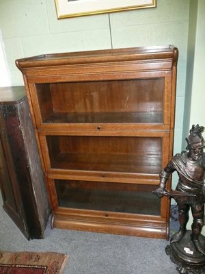 Lot 681 - A pair of Globe Wernicke type oak three height bookcases