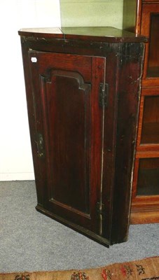 Lot 683 - A George III oak straight front hanging corner cupboard