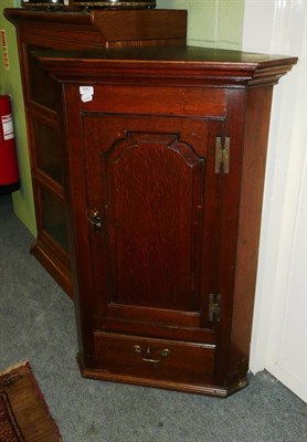 Lot 690 - A George III oak corner cupboard with drawer