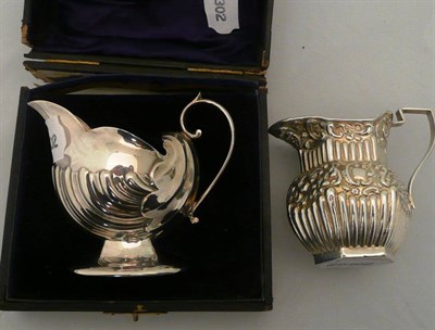 Lot 71 - Silver shell cream jug in a fitted case and another silver cream jug