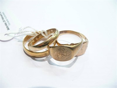 Lot 96 - A 22 carat gold wedding band, a gold band ring and two signet rings (4)