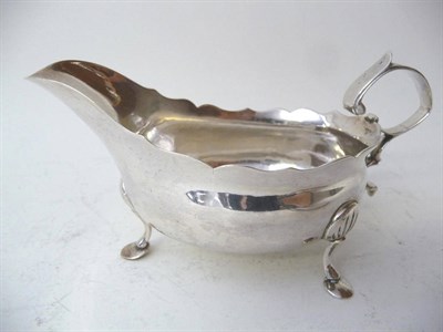 Lot 498 - A George III Sauceboat, David Crawford, Newcastle 1773, of inverted helmet shape with bracket...