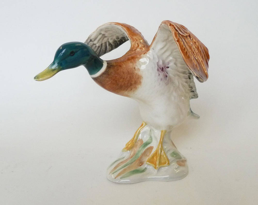 Lot 244 - A Beswick Mallard Duck settling, model No. 750, issued 1939-1965, brown, green and white gloss,...